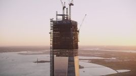 4K aerial stock footage Flying by the top of One World Trade Center, Lower Manhattan, New York, sunset Aerial Stock Footage | AX93_097