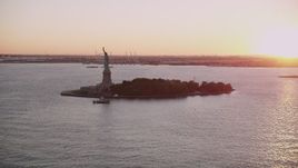 4K aerial stock footage Approaching the Statue of Liberty, New York, New York, sunset Aerial Stock Footage | AX93_106
