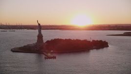 4K aerial stock footage Flying by the Statue of Liberty, New York, New York, sunset Aerial Stock Footage | AX93_107
