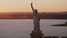 4K aerial stock footage Flying by the Statue of Liberty, New York Harbor, New York, New York, sunset Aerial Stock Footage | AX93_109