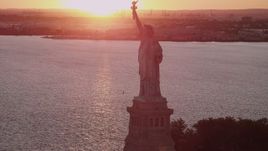 4K aerial stock footage Flying by the Statue of Liberty, New York Harbor, New York, New York, sunset Aerial Stock Footage | AX93_112