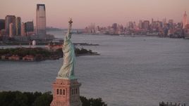 4K aerial stock footage of the Statue of Liberty, New York Harbor, Midtown, Lower Manhattan, New York, sunset Aerial Stock Footage | AX93_115
