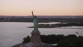 4K aerial stock footage Flying by the Statue of Liberty, New York, New York, sunset Aerial Stock Footage | AX93_122