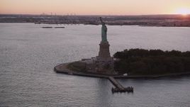 4K aerial stock footage Flying by the Statue of Liberty, New York, New York, sunset Aerial Stock Footage | AX93_123