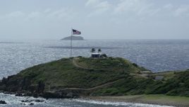 5k stock footage aerial stock footage American flag and circular building on Little St James Island, St Thomas, Virgin Islands Aerial Stock Footage | AX96_165