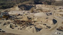 5K aerial stock footage of flying by a quarry and industrial equipment, Simi Valley, California Aerial Stock Footage | AXSF01_002