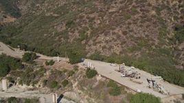 5K aerial stock footage Flying by oil rigs in the hills, Santa Paula, California Aerial Stock Footage | AXSF01_011