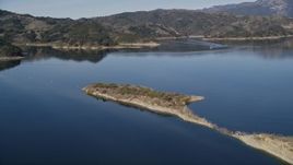 5K aerial stock footage of following an aqueduct uphill, revealing Casitas Dam, Lake Casitas, California Aerial Stock Footage | AXSF01_021