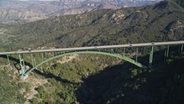 5K aerial stock footage of flying by the Cold Springs Canyon Arch Bridge, Santa Ynez Mountains, California Aerial Stock Footage | AXSF01_037