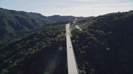 5K aerial stock footage track black SUV crossing Cold Springs Canyon Arch Bridge, Santa Ynez Mountains, California Aerial Stock Footage | AXSF01_038