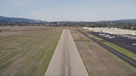 5K aerial stock footage tilt from vineyard to reveal runway, approach for landing, Santa Ynez Airport, California Aerial Stock Footage | AXSF01_051