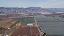 5K aerial stock footage Fly by geometric fields of farmland, Sierra Madre Mountains, Santa Maria, California Aerial Stock Footage | AXSF02_004