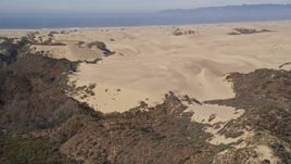5K aerial stock footage of approaching sand dunes, ATV riders, Pismo Dunes, California Aerial Stock Footage | AXSF02_015