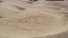 5K aerial stock footage of flying by ATV riders and sand dunes, Pismo Dunes, California Aerial Stock Footage | AXSF02_016