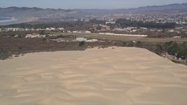 5K aerial stock footage of a bird's eye view of helicopter shadow on sand dunes, reveal Oceano County Airport, Pismo Dunes, California Aerial Stock Footage | AXSF02_026