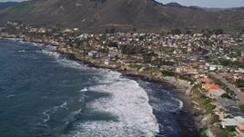 5K aerial stock footage flying over rolling waves by oceanfront homes, Shell Beach, California Aerial Stock Footage | AXSF02_035