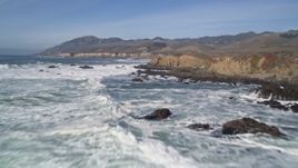 5K aerial stock footage of flying over waves rolling toward coastal cliffs at Avila Beach, California Aerial Stock Footage | AXSF02_048