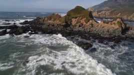 5K aerial stock footage fly over waves, rock formations, tilt to reveal coastal cliffs, Avila Beach, California Aerial Stock Footage | AXSF02_051