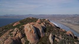 5K aerial stock footage tilt from bay, reveal Morro Rock, Morro Strand State Beach, Morro Bay, California Aerial Stock Footage | AXSF03_003