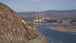 5K aerial stock footage of flying by the Dynegy Power Plant, eclipsed by Morro Rock, Morro Bay, California Aerial Stock Footage | AXSF03_005