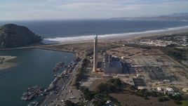 5K aerial stock footage of the Dynegy Power Plant with smoke stacks, reveal Morro Rock, Morro Bay, California Aerial Stock Footage | AXSF03_008