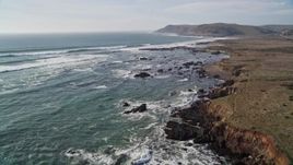 5K aerial stock footage fly over grassland, coastal cliffs and empty beach, and tilt up to follow the coast, Estero Bay, California Aerial Stock Footage | AXSF03_012