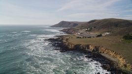 5K aerial stock footage of flying by Highway 1, pan to reveal coastal abalone farm, Cayucos, California Aerial Stock Footage | AXSF03_013