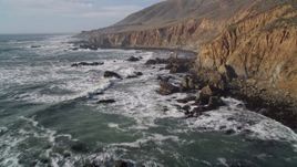 5K aerial stock footage of flying low over rugged coastal cliffs and ocean waves, Cambria, California Aerial Stock Footage | AXSF03_021