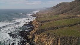 5K aerial stock footage tilt from crashing waves to coastline to reveal coastal cliffs, Cambria, California Aerial Stock Footage | AXSF03_023