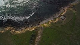 5K aerial stock footage of a bird's eye view of the rocky coastline and coastal cliffs, Cambria, California Aerial Stock Footage | AXSF03_025