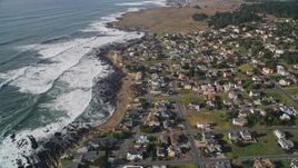 5K aerial stock footage of a bird's eye view of rugged coastal cliffs, tilt to homes near ocean, Cambria, California Aerial Stock Footage | AXSF03_026