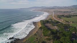 5K aerial stock footage of tilting from the ocean to follow coastline near Highway 1, Cambria, California Aerial Stock Footage | AXSF03_031