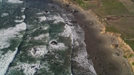 5K aerial stock footage tilt from ocean to reveal isolated beachfront mansion, Cambria, California Aerial Stock Footage | AXSF03_033