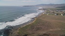 5K aerial stock footage Tilt to reveal ocean waves rolling into the coast, San Simeon, California Aerial Stock Footage | AXSF03_034