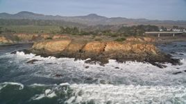 5K aerial stock footage of flying away from jagged coastal cliffs, San Simeon, California Aerial Stock Footage | AXSF03_036