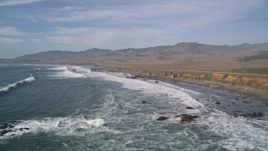 5K aerial stock footage fly over ocean waves by Highway 1 on the coast, San Simeon, California Aerial Stock Footage | AXSF03_037