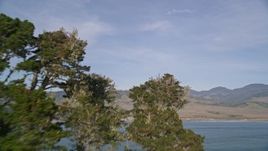 5K aerial stock footage fly low over the ocean and a peninsula to reveal San Simeon Bay, San Simeon, California Aerial Stock Footage | AXSF03_045