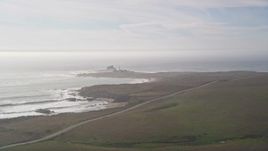 5K aerial stock footage approach Piedras Blancas Light Station from Highway 1 on Point Piedras Blancas, California Aerial Stock Footage | AXSF03_053
