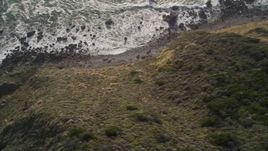 5K aerial stock footage of a bird's eye view of waves below coastal cliffs, Big Sur, California Aerial Stock Footage | AXSF03_067