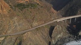 5K aerial stock footage of flying by a small bridge on Highway 1, above coastal cliffs, Big Sur, California Aerial Stock Footage | AXSF03_072