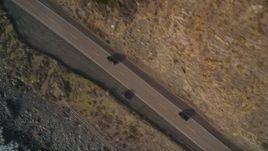5K aerial stock footage of a bird's eye view of black cars on Highway 1, above coastal cliffs, Big Sur, California Aerial Stock Footage | AXSF03_073