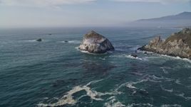 5K aerial stock footage approach and orbit a large rock formation off the coast, Big Sur, California Aerial Stock Footage | AXSF03_077