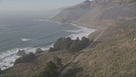 5K aerial stock footage fly over highway and ocean waves, approach small bridge on Highway 1 and coastal cliffs, Big Sur, California Aerial Stock Footage | AXSF03_091