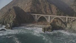 5K aerial stock footage of flying over ocean kelp to reveal small bridge on Highway 1 and cliffs, Big Sur, California Aerial Stock Footage | AXSF03_092