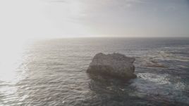 5K aerial stock footage of flying low over ocean past birds perched on rock formation, Big Sur, California Aerial Stock Footage | AXSF03_099