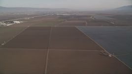 5K aerial stock footage of flying by a landscape of vast farm fields, Salinas, California Aerial Stock Footage | AXSF03_114