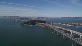 5K aerial stock footage approach Bay Bridge, Yerba Buena Island, with view of Downtown San Francisco, California Aerial Stock Footage | AXSF05_006