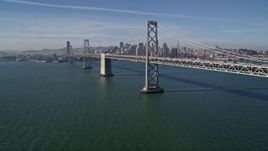 5K aerial stock footage tilt to reveal and fly overthe Bay Bridge toward Downtown San Francisco skyline, California Aerial Stock Footage | AXSF05_008