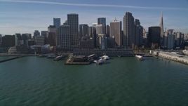 5K aerial stock footage tilt from bay to reveal and fly over the Ferry Building into Downtown San Francisco, California Aerial Stock Footage | AXSF05_009