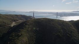 5K aerial stock footage flyby the Marin Headlands, eclipsing Golden Gate Bridge, San Francisco skyline in background, Marin County, California Aerial Stock Footage | AXSF05_045